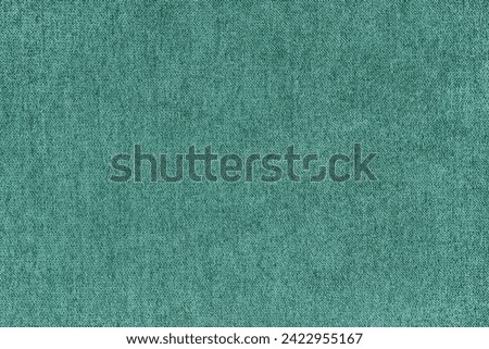 Texture background of velours jacquard turquoise fabric. Upholstery texture fabric, velvet furniture textile material, design interior, decor. Fleecy fabric texture close up, backdrop, wallpaper.
