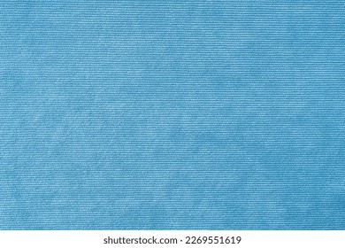 Texture background of velours light blue fabric. Upholstery velveteen texture fabric, corduroy furniture textile material, design interior, decor. Ridge fabric texture close up, backdrop, wallpaper.