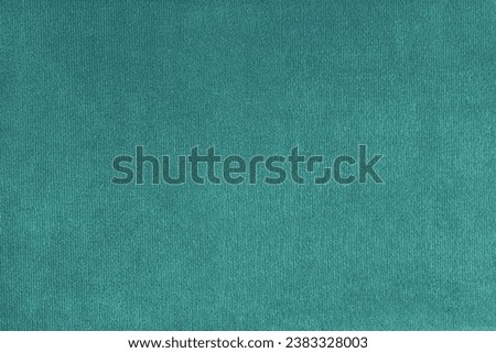 Texture background of velours turquoise fabric. Upholstery texture fabric, velvet furniture textile material, design interior, decor. Fleecy fabric texture close up, backdrop, wallpaper.