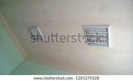 Texture or background, wallpaper of a white celing with daylight lamps in a public institution during the day.