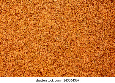 Texture background of the yellow plastic doormat.