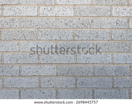 Texture of baked earth-colored bricks on a wall