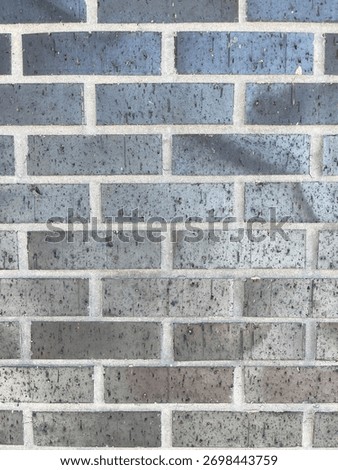 Texture of baked earth-colored bricks on a wall