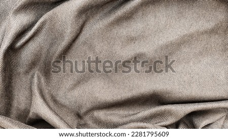The texture of a beige fabric for background. Burlap pleats fabric abstract texture background and frame