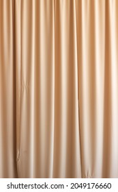 Texture Beige Satin Fabric Shiny Surface Background For Photo Vertical Folds Hold On The Curtain