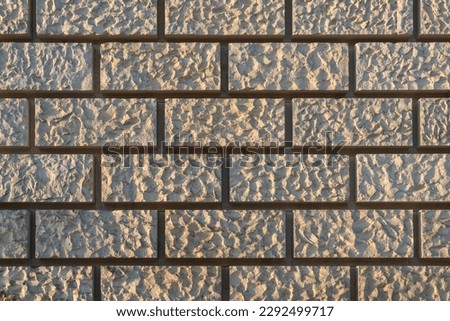 texture of a beige stone wall as background, natural stone wall texture as background. Close-up of the sandstone facade of the reichstag building
