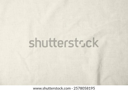 Texture of beige tablecloth as background, top view