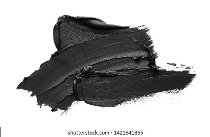 Texture of black crushed eyeliner or black acrylic paint isolated on white background