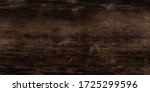 Texture of black and dark brown old wood. Charred and burnt old Board with knots. Wide burned board texture close-up, panoramic banner.