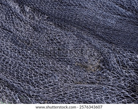 Texture of black fishnet being dried