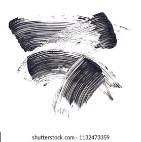 Texture of black mascara for eyelashes isolated on white background. Smear of black mascara for eyelashes on white background. Black mascara smears on white background