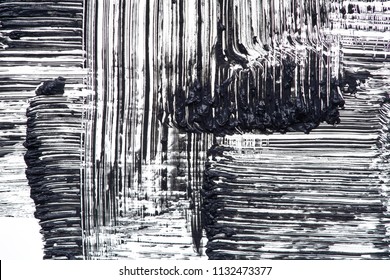 Texture of black mascara for eyelashes isolated on white background. Smear of black mascara for eyelashes on white background. Black mascara smears on white background