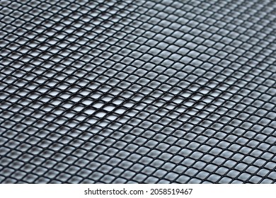 Texture: black metal iron grating, grid or stainless steel grate on white background. Venting, ventilation with geometric design pattern