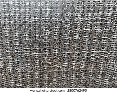 ​Close up texture of black plastic shading net or paranet used for greenhouse and garden protection