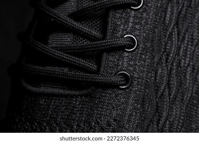 The texture of a black rag sneaker with laces close-up. - Powered by Shutterstock