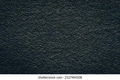 Texture Of Black Woolen Or Dark Tweed Fabric Close-up.