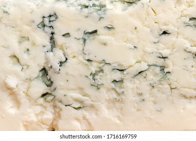 Texture of the blue cheese with blue-grey mold on cut of piece close-up, background
 - Powered by Shutterstock