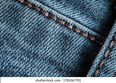 Texture Of Blue Denim. Denim Machine Stitch. Can Be Used As Background For Lettering Or Design. Factory Tailoring. Cotton Fabric. Jeans Fashion.