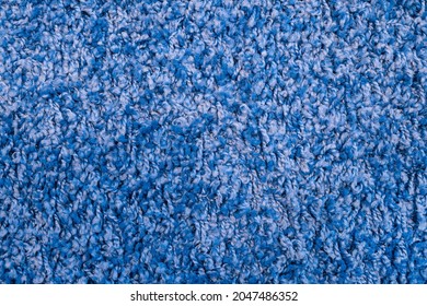 Texture Of Blue Fabric Carpet With Long Pile Close-up. Fluffy Blue Frieze Fur Carpet Texture.