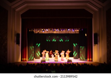 Texture Blur And Defocus, Background For Design. Stage Light At A Concert Show. Singers, Musicians And Dancers Perform On Scene.