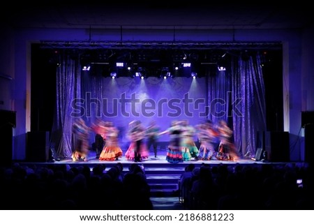 Texture blur and defocus, background for design. Stage light at a concert show. Artists perform on scene in light and smoke.