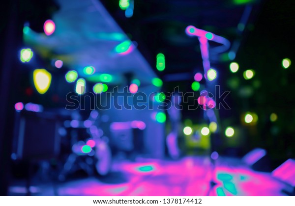 texture blur scene multicolored lights and smoke in\
concert with silhouettes of peopleBackground for design blur\
texture actors on stage