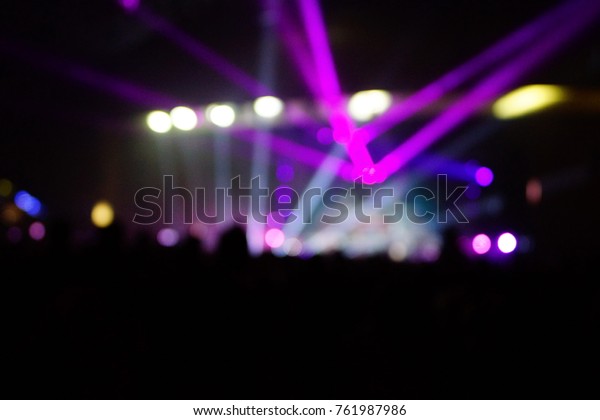 texture blur scene multicolored lights and smoke in\
concert with silhouettes of peopleBackground for design, blur\
texture, actors on\
stage