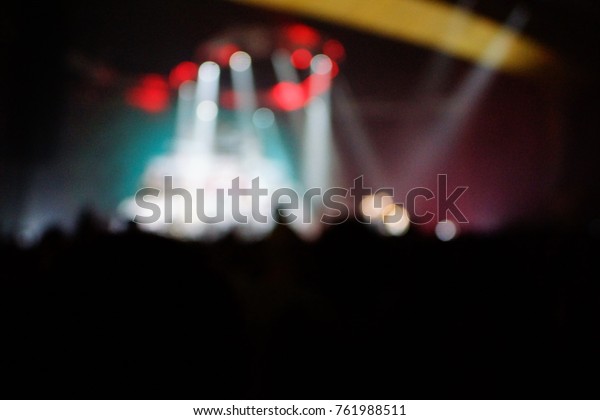 texture blur scene multicolored lights and smoke in\
concert with silhouettes of peopleBackground for design, blur\
texture, actors on\
stage