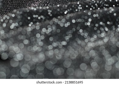 Texture With Bokeh Of Shiny Lurex Fabric Silver And Black Color.
