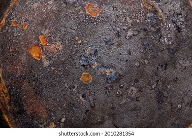 Texture Of The Bottom Of An Old Cast Iron Pan With Rust Elements