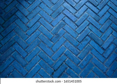 The texture of the brick wall of many rows of bricks painted in blue color