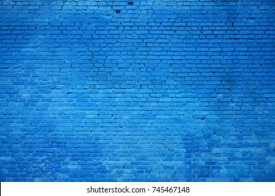 The texture of the brick wall of many rows of bricks painted in blue color - Shutterstock ID 745467148