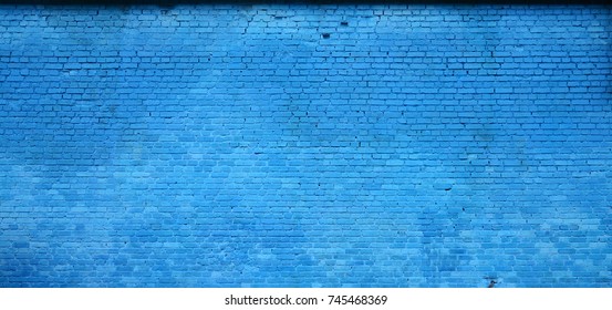 The texture of the brick wall of many rows of bricks painted in blue color