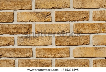 Texture of brick wall. new brickwork. Samples of wall or fence are presented at exhibitions. Yellow brick close up.