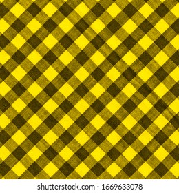 The texture of the bright yellow of binding gingham fabric. Yellow textile background. Fabric plaid. Close-up