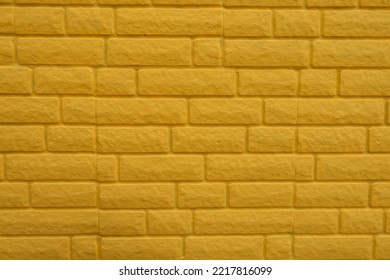 Texture Of Bright Yellow Painted Brick Veneer Wall