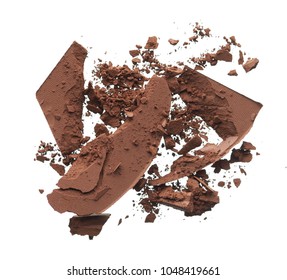 Texture of broken dark brown eye shadow isolated on white background. Macro texture of broken chocolate powder on white background