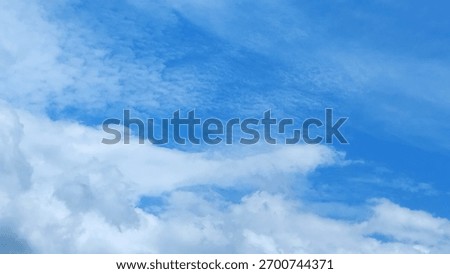Texture of broken white clouds and blue sky.