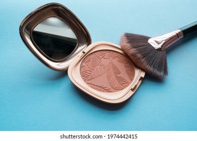  Texture Bronzer And Makeup Brush On A Blue Background, Closeup