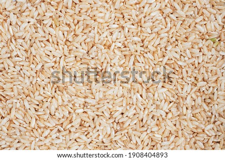 Texture Brown rice raw long grain. background close up
