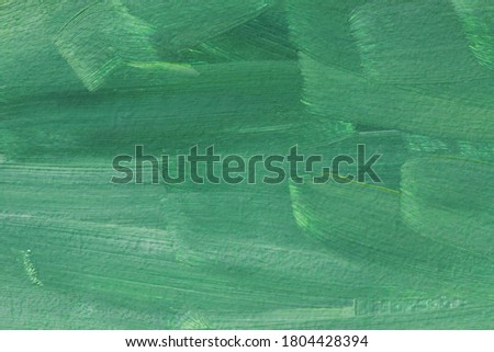 The texture of the canvas, coated with oil paints. Green and mint colors, copy space. The concept of a creative atmosphere, artistic events, education, etc.
