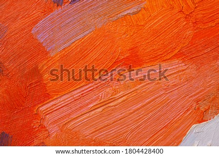 The texture of the canvas, coated with oil paints. Gradient in orange colors, copy space. The concept of a creative atmosphere, artistic events, education, etc.