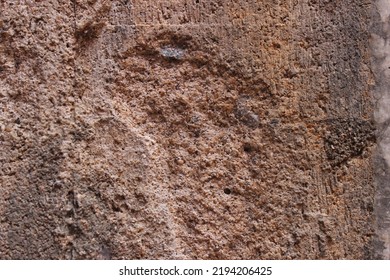 A Texture Of The Cement Wall Outside The Building That Has Begun To Peel And Crack.