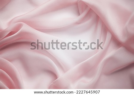 Texture chiffon fabric in pink color for backgrounds. silk fabric. selective focus