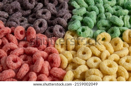 Texture with colorful fruit breakfast cereal separated by color and without milk