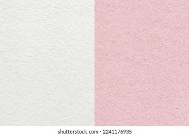 Texture of craft light pink and white paper background, half two colors, macro. Structure of vintage dense rose cardboard. Felt backdrop closeup.