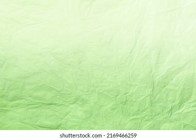 Texture crumpled light green wrapping paper and gradient  closeup  Light olive old background  Material backdrop