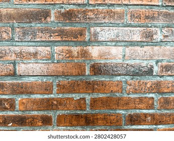 Texture of dark brown or red brickwork in a restaurant. Its old and weathered look adds to a classical retro appeal.