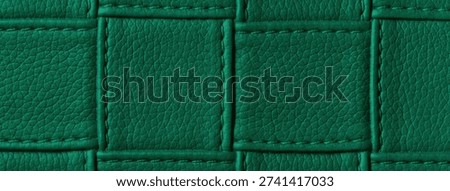 Texture dark emerald leather background with quilted stitched pattern, macro. Abstract deep green upholstery surface.