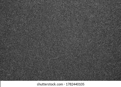 The texture of dense black synthetic fabric.The texture of a dense gray carpet.Grey carpet background.